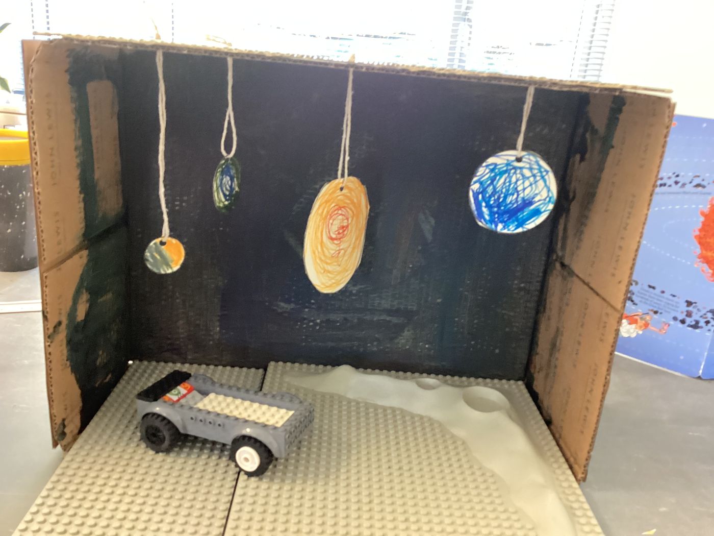 A learner-built cardboard solar system with a LEGO lunar rover